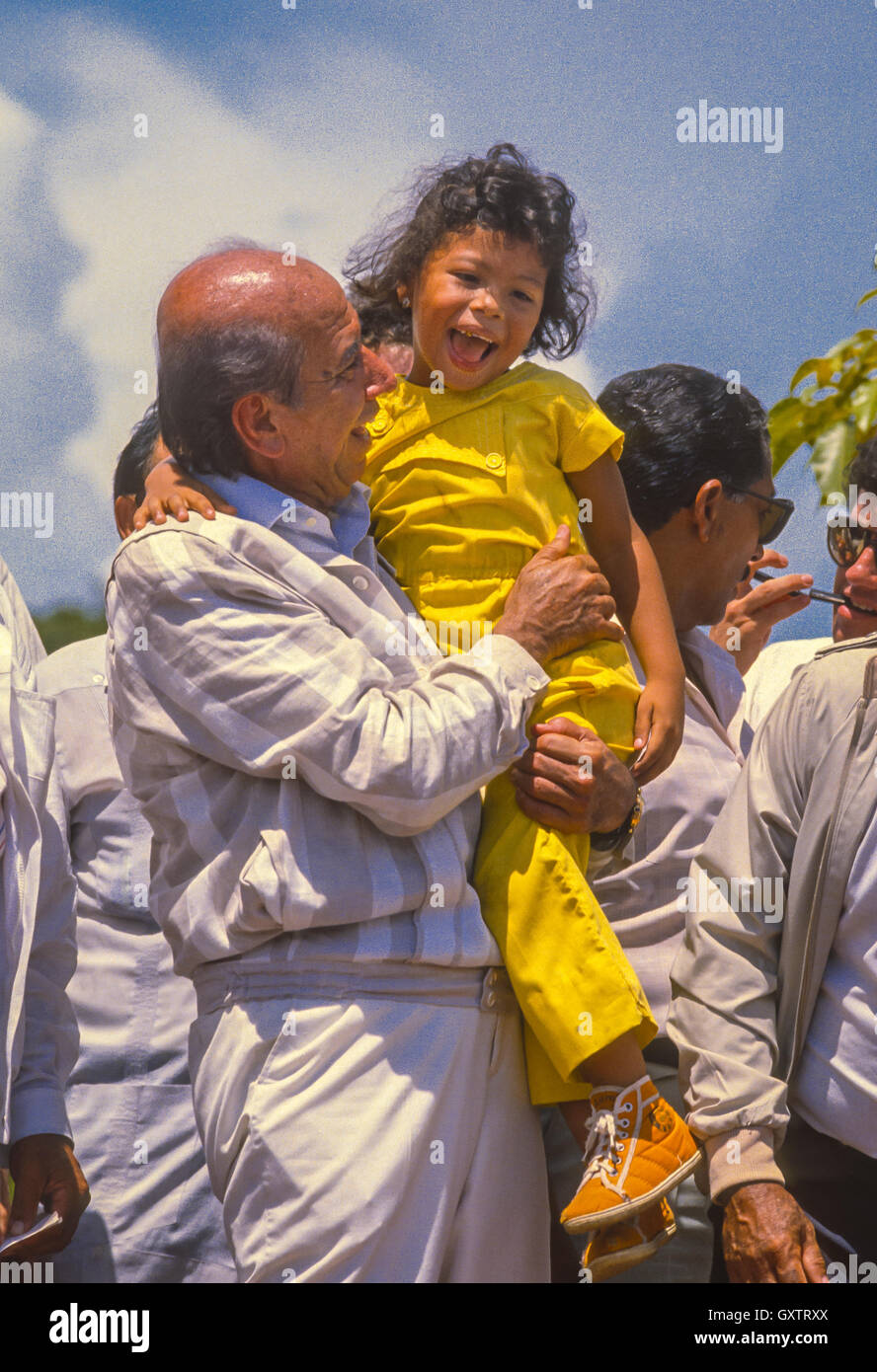 CIUDAD GUAYANA, VENEZUELA - Presidential candidate Carlos Andres Perez campaigning, picks up young girl, October1988. Stock Photo