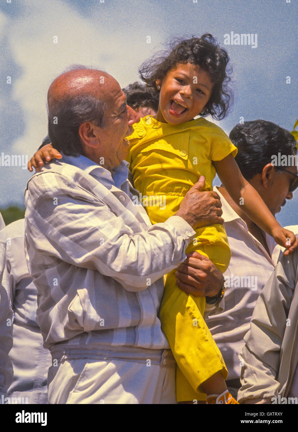 CIUDAD GUAYANA, VENEZUELA - Presidential candidate Carlos Andres Perez campaigning, picks up young girl. 1988 Stock Photo