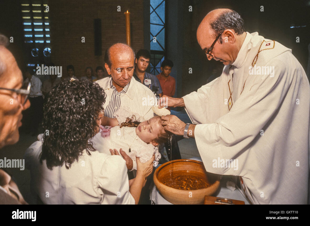 CIUDAD GUAYANA, VENEZUELA - Presidential candidate Carlos Andres Perez campaigning, baptism of child, Godfather, at El Robles Church. October 1988 Stock Photo