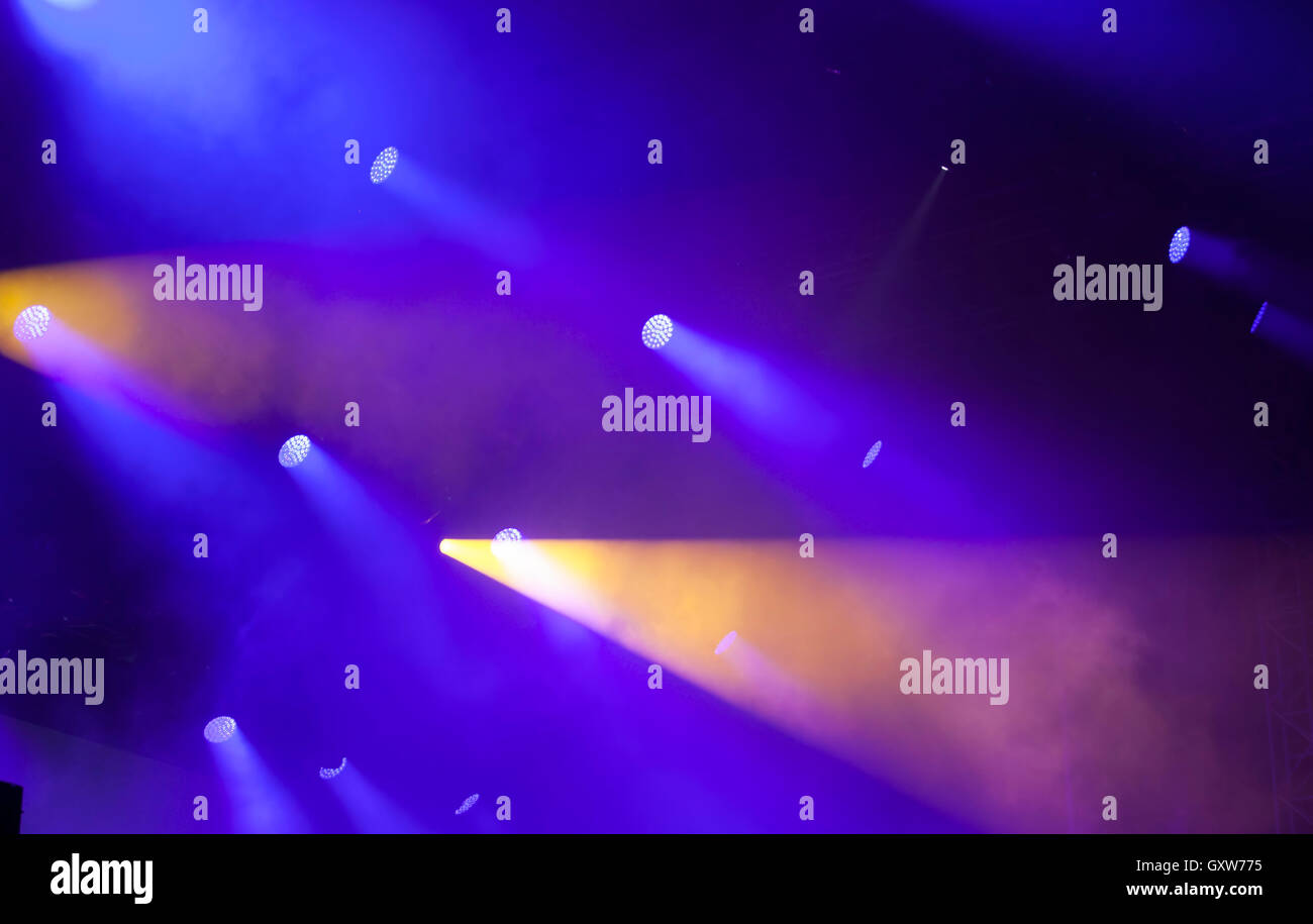 Stage lights on electric concert on blue background Stock Photo - Alamy