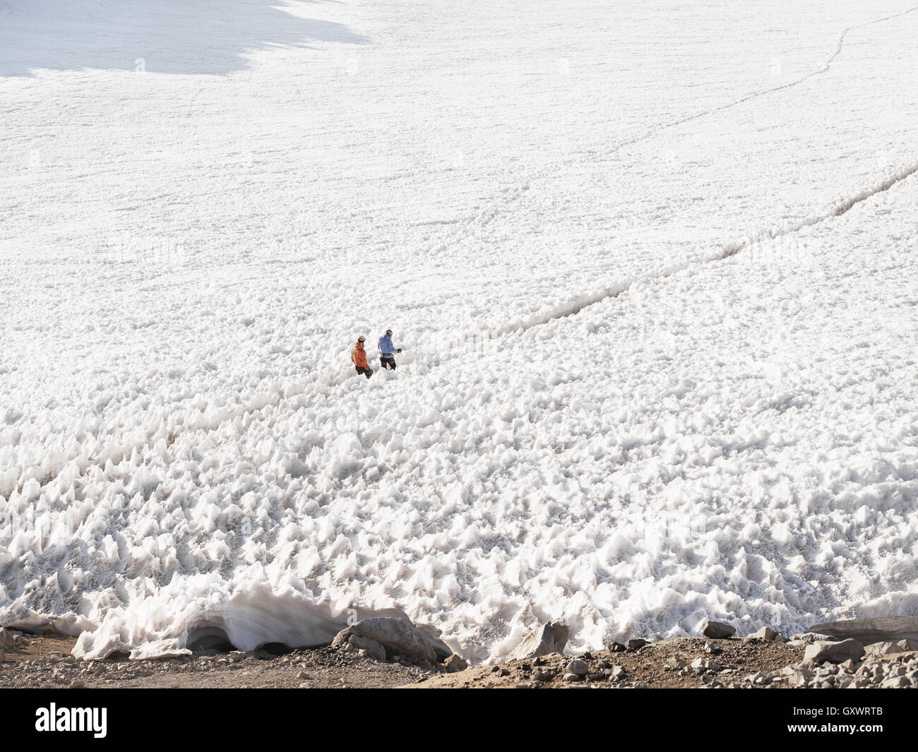 HIkers journey through snow while trekking up Mt. Rainier Stock Photo