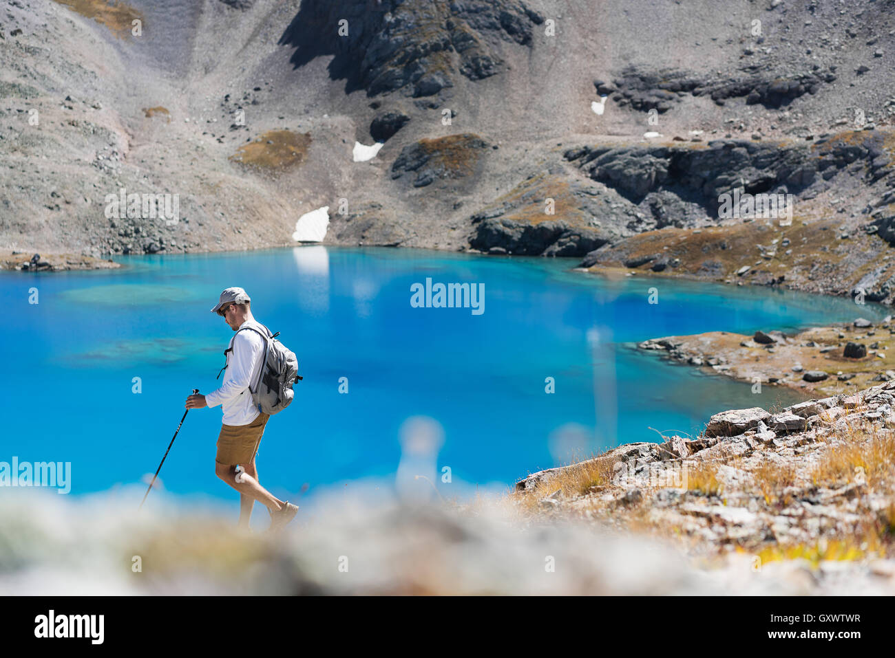 A hiker explores the mountain glacial water near Telluride, Colorado Stock Photo