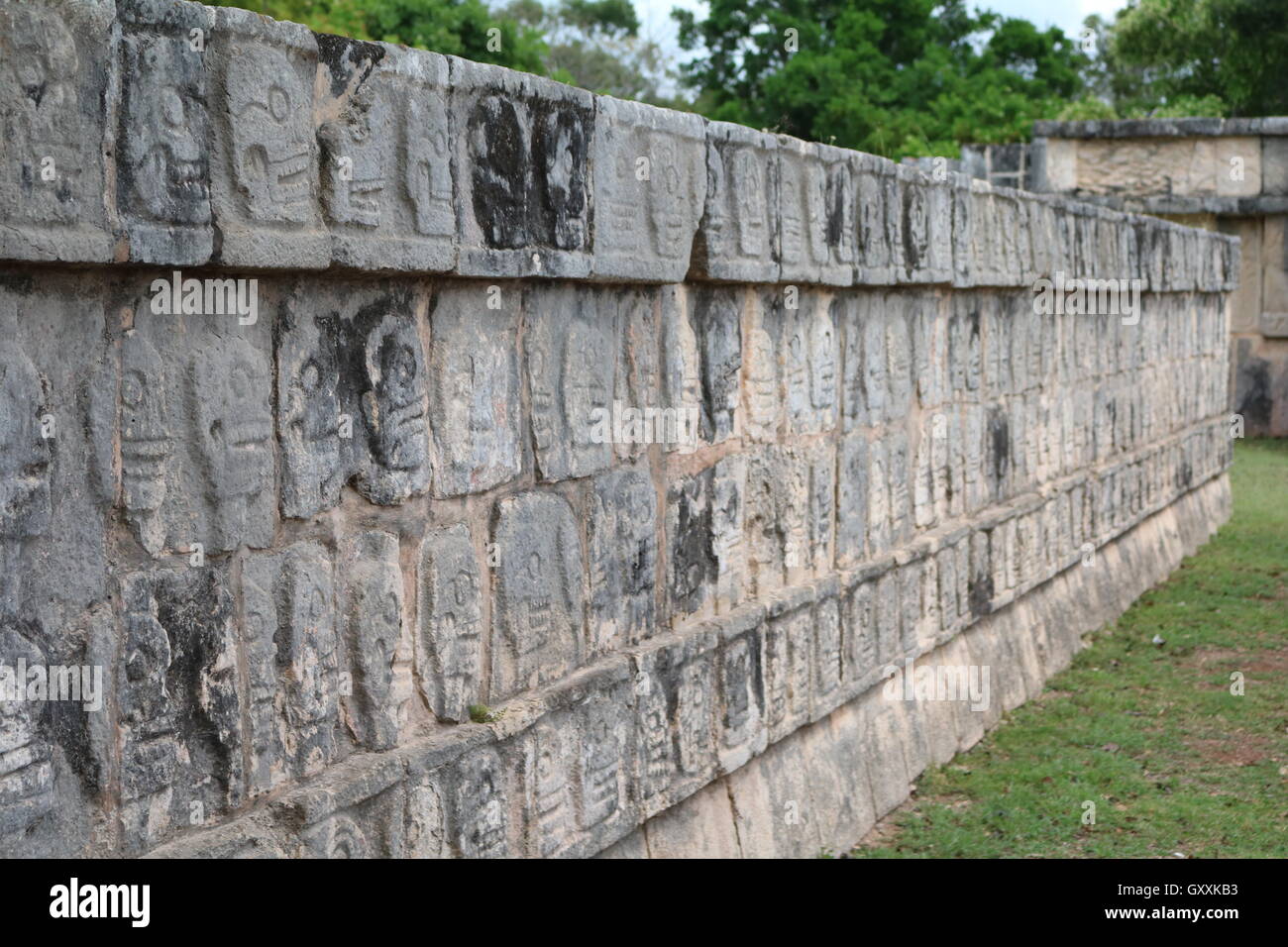 Ancient Aztec Skull wall art found at Chichen Itza, Mexico Stock Photo