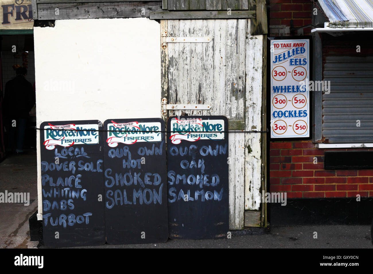 Signs advertising fresh fish and seafood outside shop at Rock-A-Nore, Old Town, Hastings, East Sussex, England, UK Stock Photo