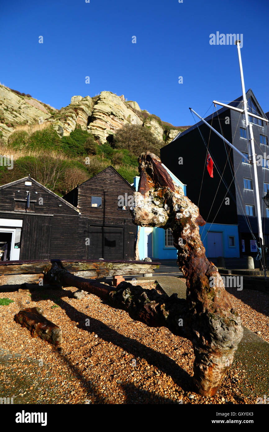 Rusty old anchor and new apartment building (R) below East Hill at Rock