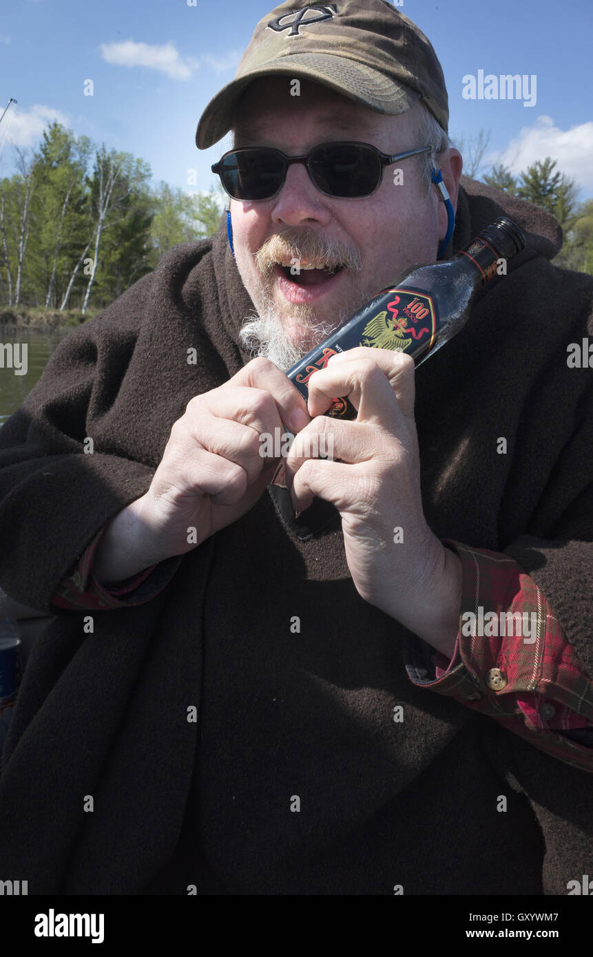 On a bad fishing day a fisherman's only comfort is a bottle of Rumple Minze. Nisswa Minnesota MN USA Stock Photo