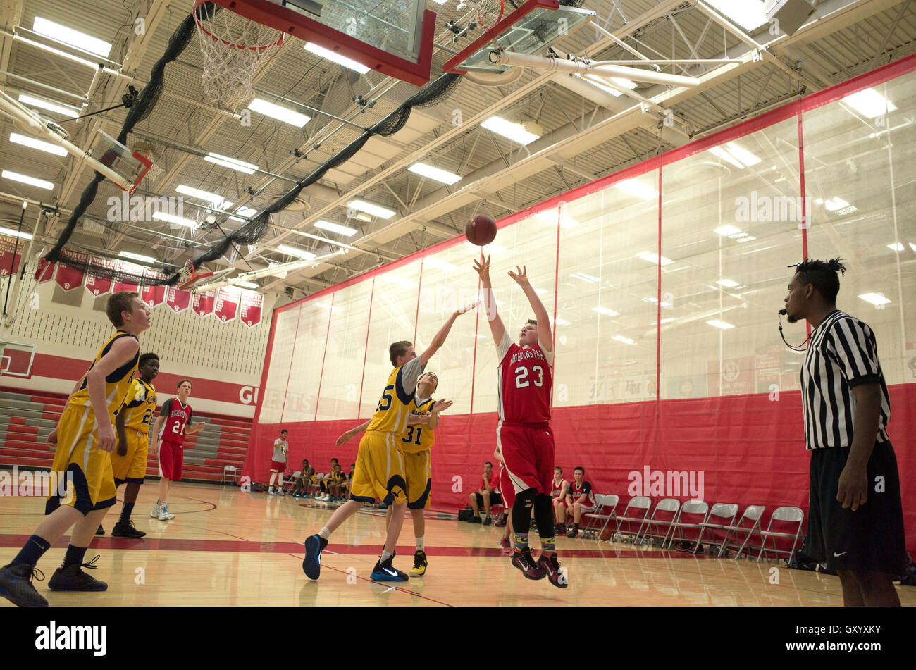 Teen basketball player leaps in air to make jump shot. North High School White Bear Lake Minnesota MN USA Stock Photo