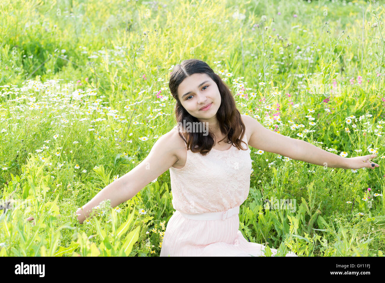 Teenage girl resting on flower meadow Stock Photo - Alamy
