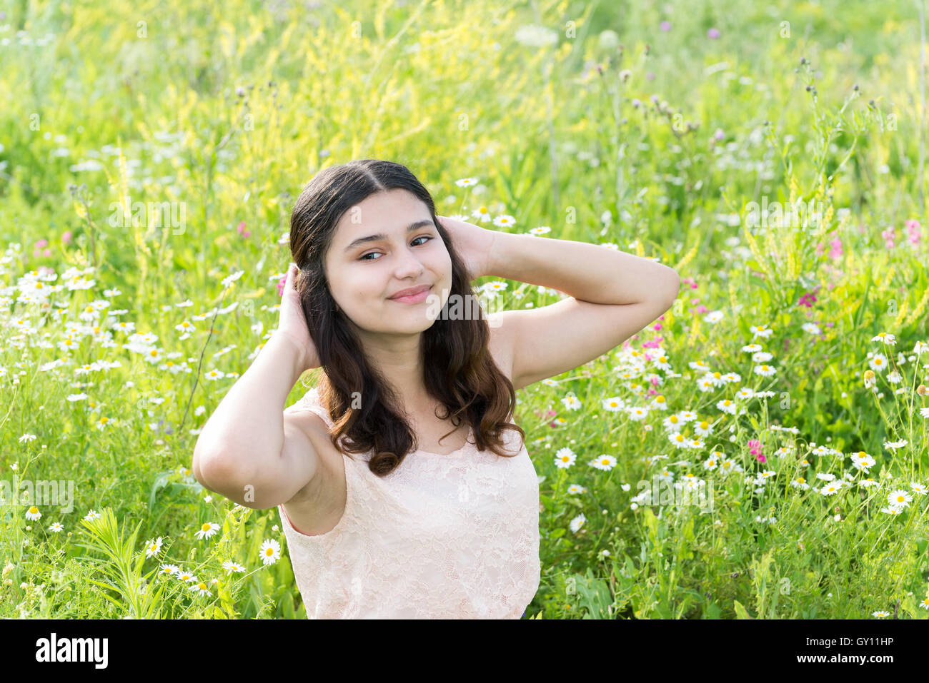 Teenage girl resting on flower meadow Stock Photo - Alamy