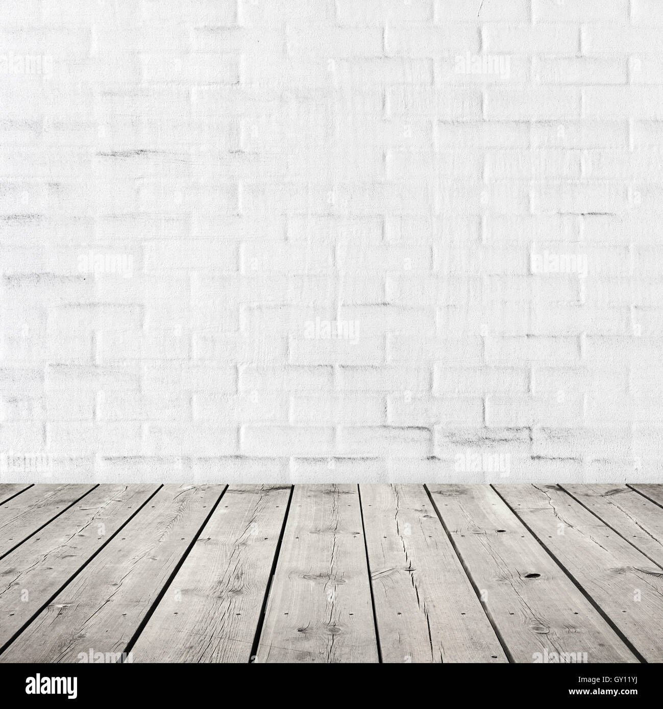 Gray wooden floor and white brick wall with plastering. Abstract square interior background Stock Photo