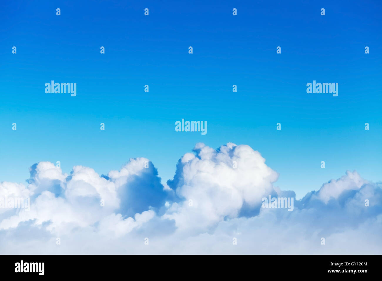 Cloudscape with white cumulus clouds in bright blue sky, natural photo background Stock Photo