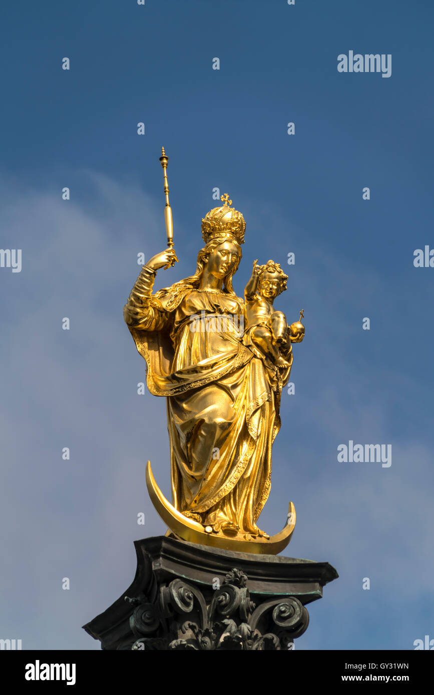 golden Virgin Mary atop the Mariensäule on the central square Marienplatz in Munich, Bavaria, Germany Stock Photo