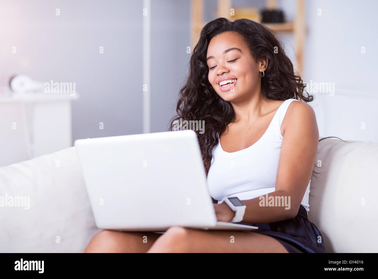 Cheerful beautiful young woman using laptop Stock Photo - Alamy
