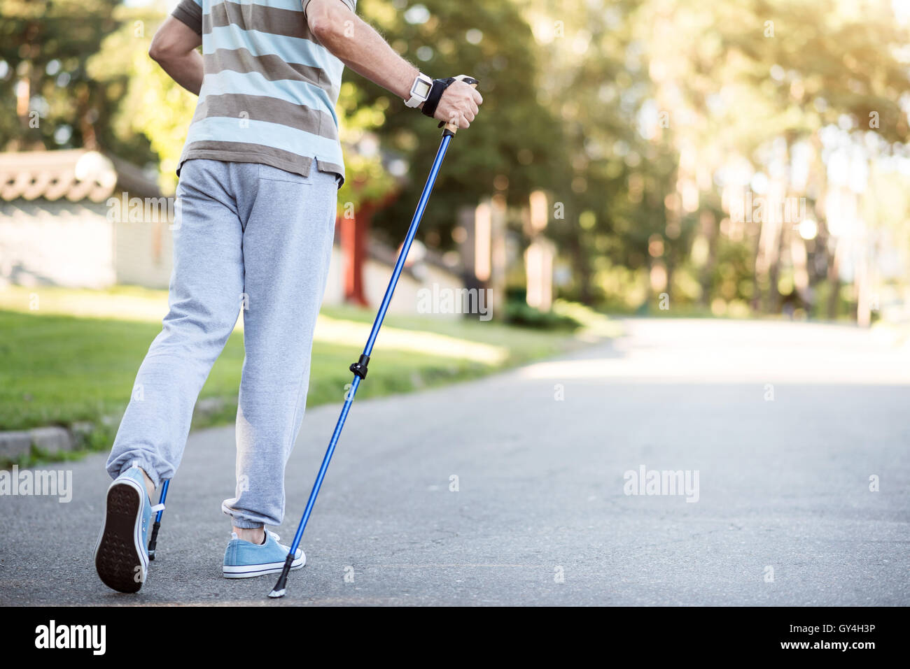Elderly man moving along his neighborhood with tracking stick Stock Photo