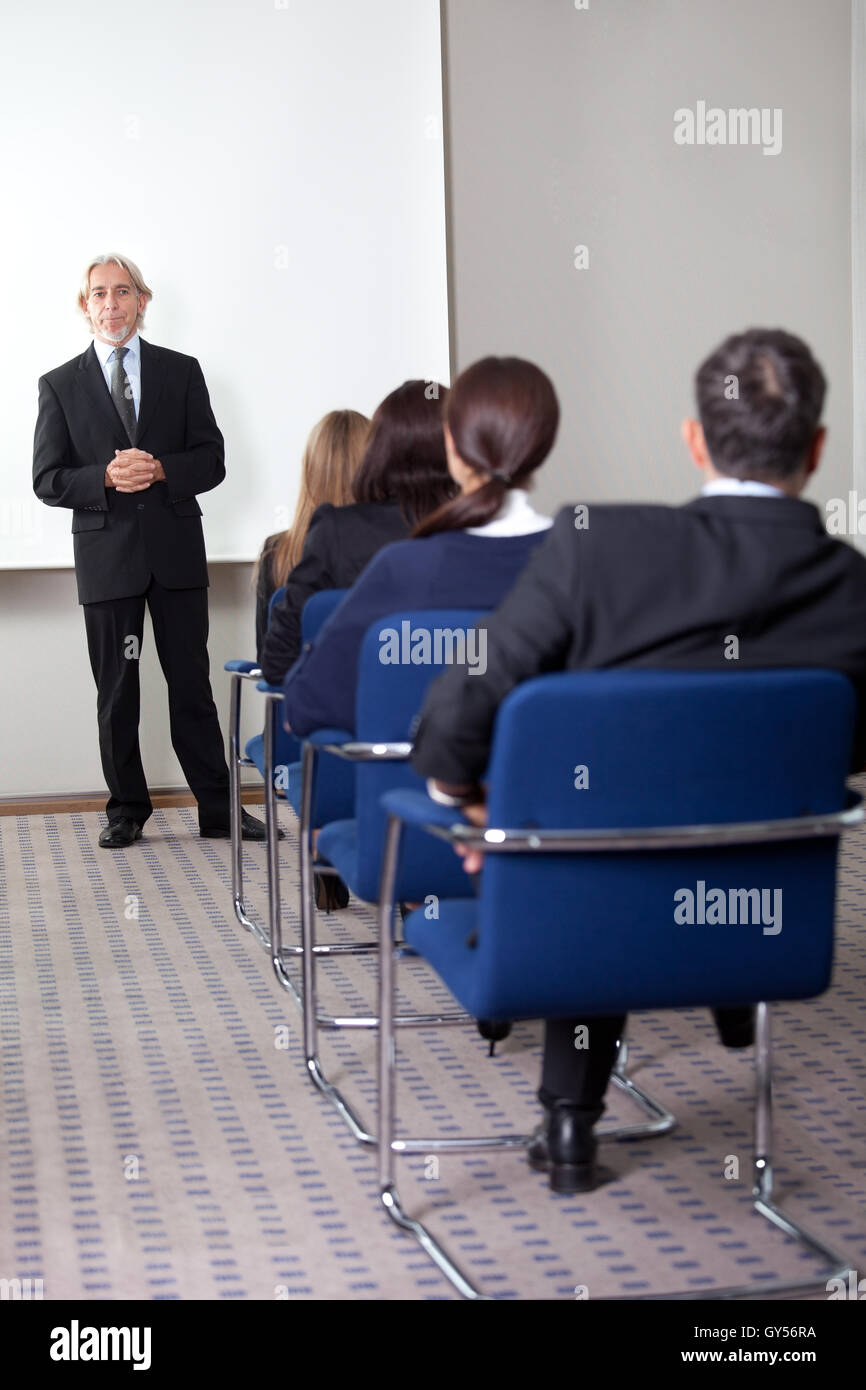 Mature business man giving presentation Stock Photo - Alamy