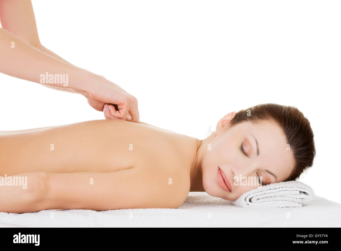 Preaty woman relaxing being massaged in spa saloon. Stock Photo