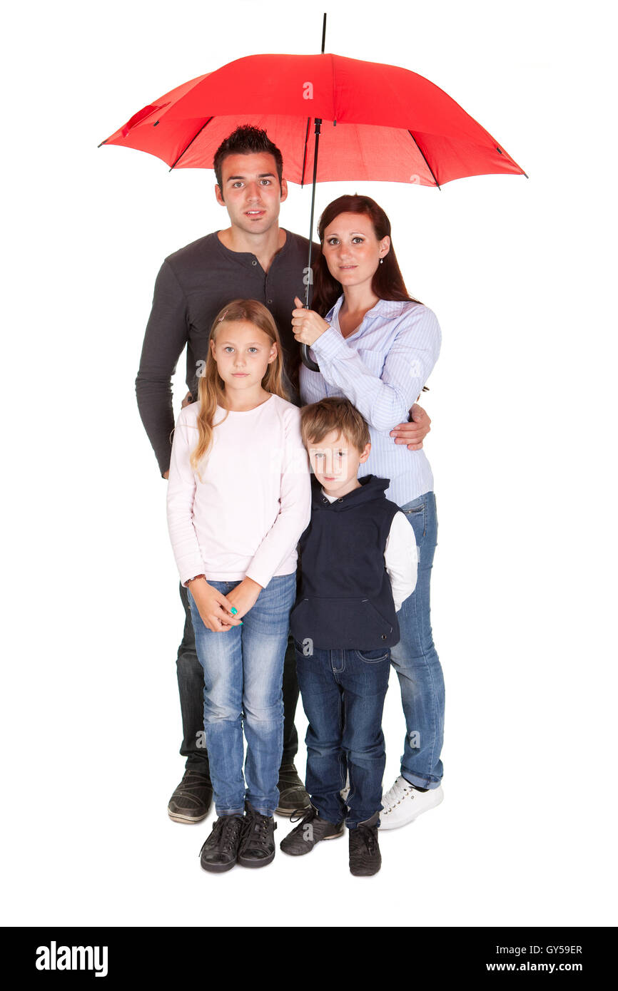 Happy young family standing under one umbrella Stock Photo Alamy