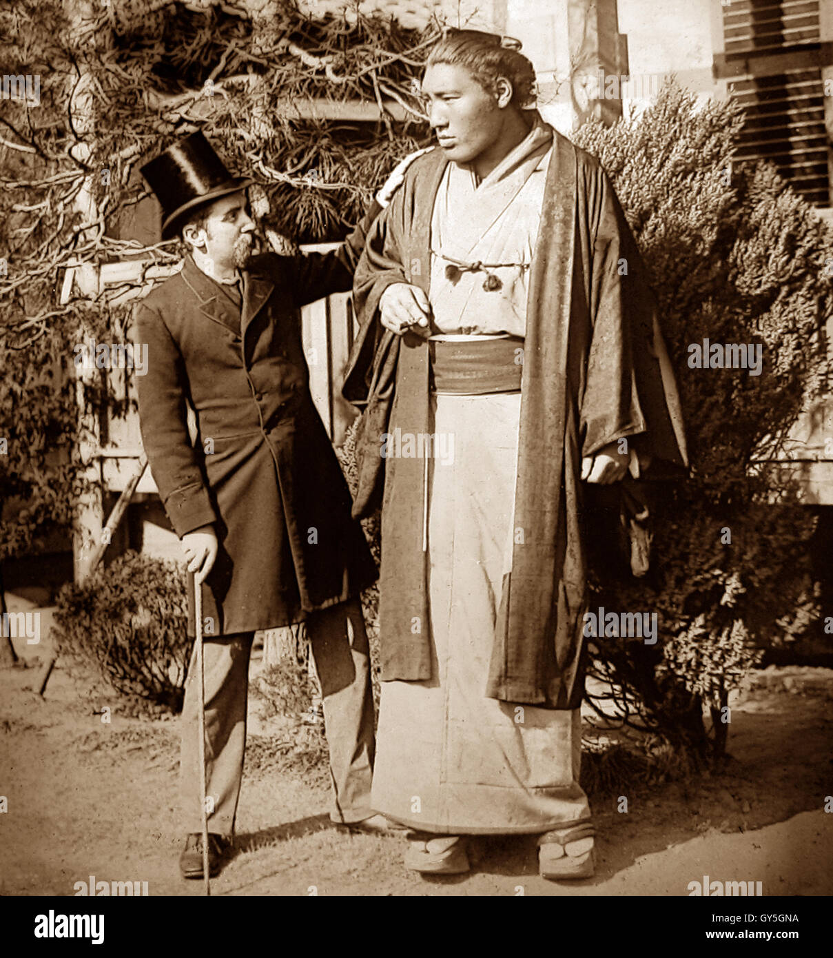 Professor Burton and Ozutsu Manemon also known as Taiho, the 18th Yokozuna (Sumo wrestler) taken in 1895. See description for more information. Stock Photo