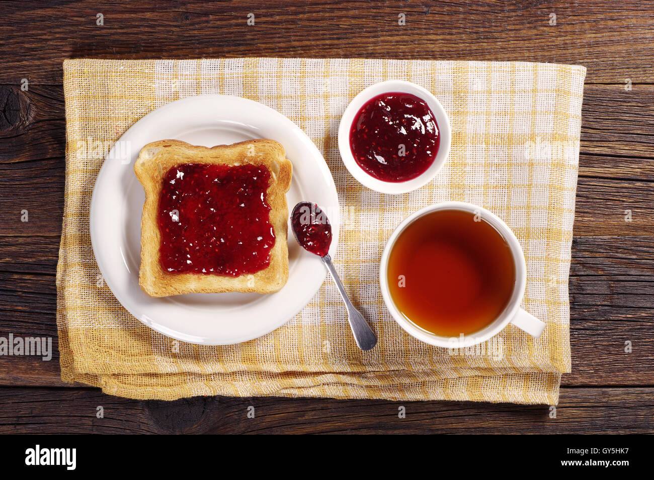 Cup Of Tea And Toast With Jam On Yellow Tablecloth Top View Stock Photo Alamy