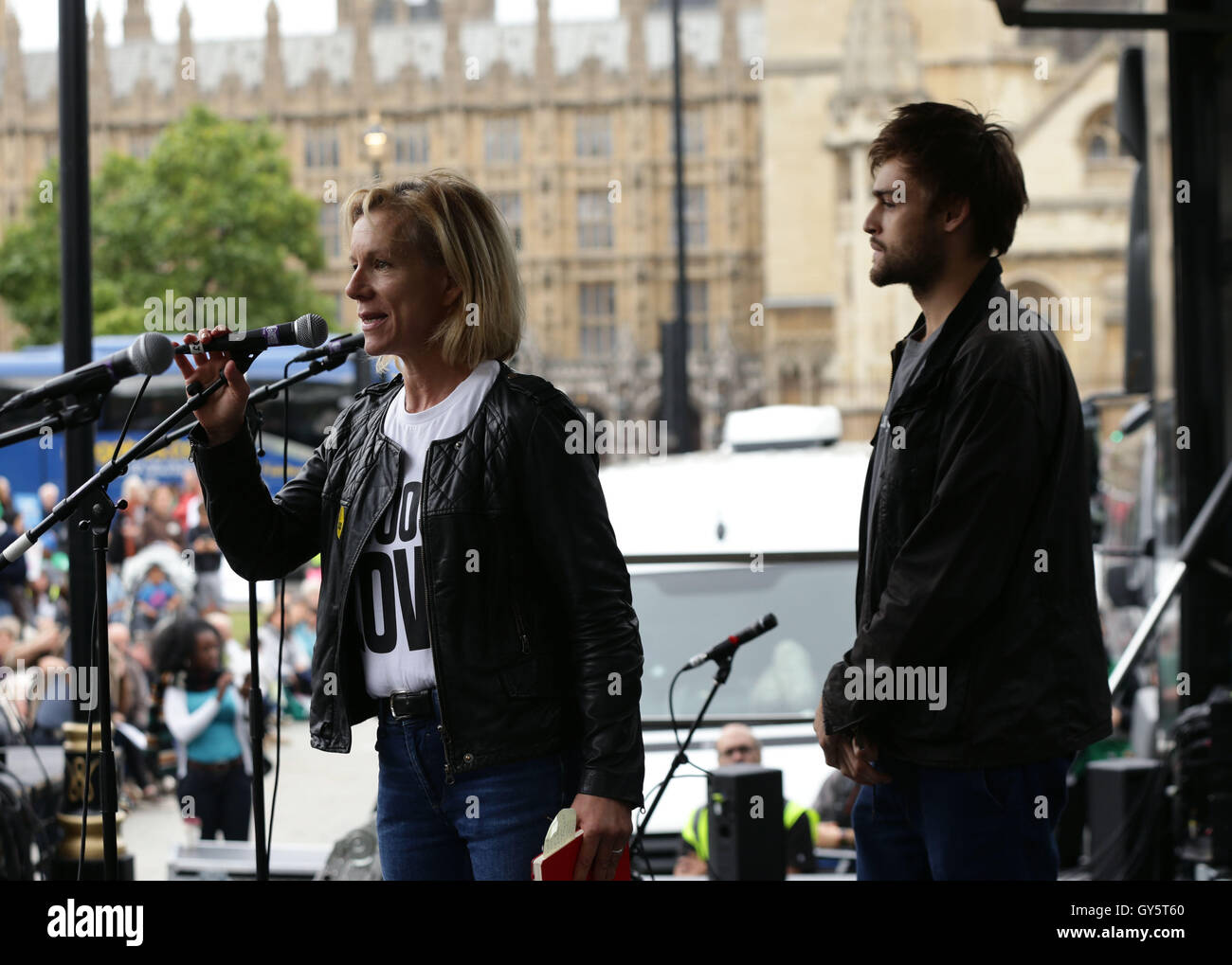 Juliet Stevenson and Douglas Booth on stage addressing the crowd during a rally in Parliament Square, London, after taking part in the Refugees Welcome March in a bid to urge the Government to take more action on the migrant crisis. Stock Photo
