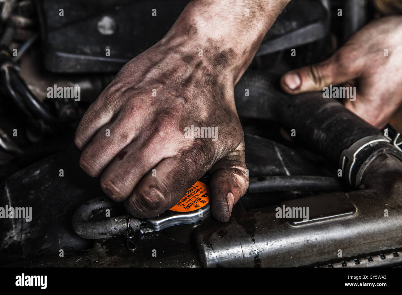 Working men with dirty hands and tools Stock Photo