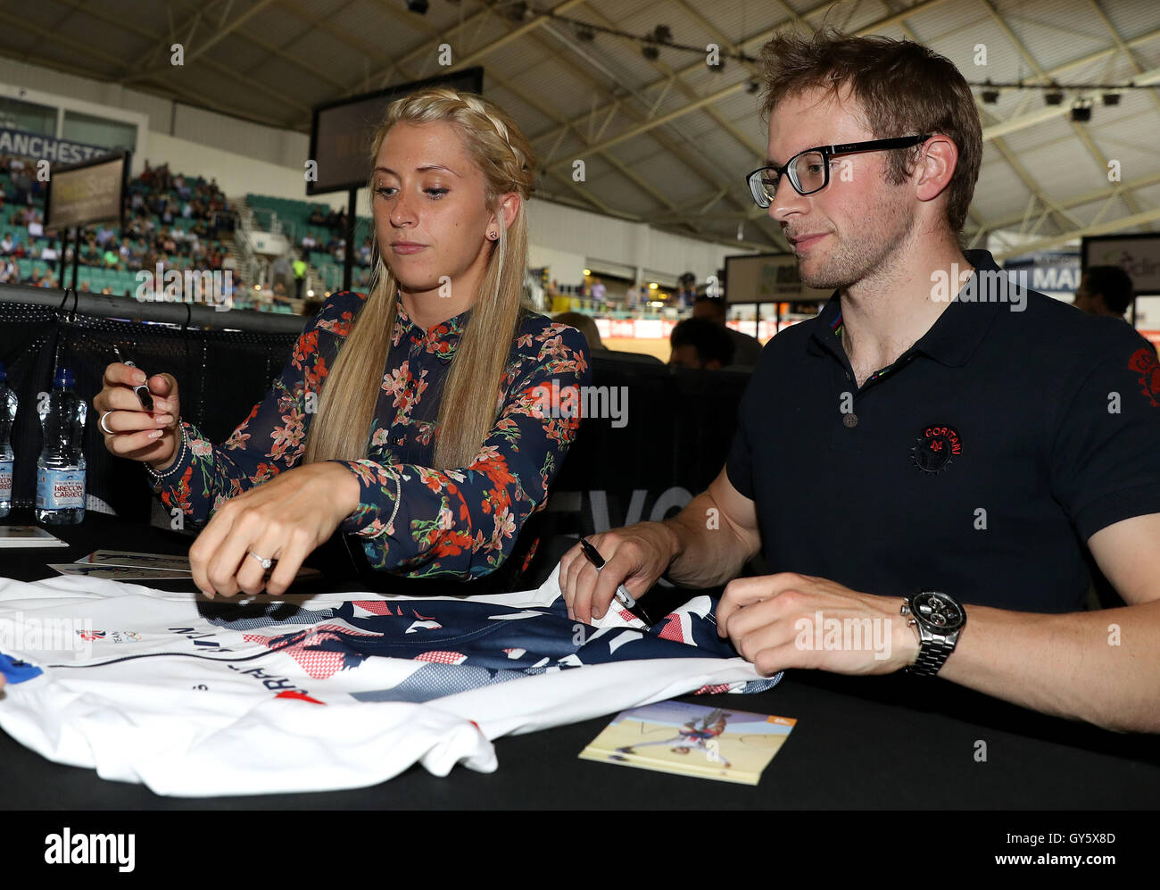 Laura Trott and Jason Kenny sign autographs before the Revolution Series at the National Cycling Centre, Manchester. PRESS ASSOCIATION Photo. Picture date: Saturday September 17, 2016. See PA story CYCLING Manchester. Photo credit should read: Martin Rickett/PA Wire. RESTRICTIONS: Use subject to restrictions. Editorial use only. No commercial use. Call +44 (0)1158 447447 for further information. Stock Photo