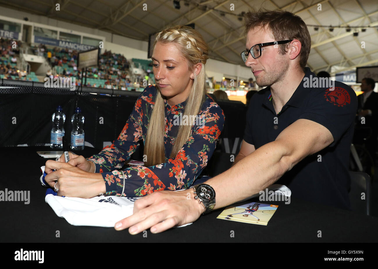 Laura Trott and Jason Kenny sign autographs before the Revolution Series at the National Cycling Centre, Manchester. Stock Photo