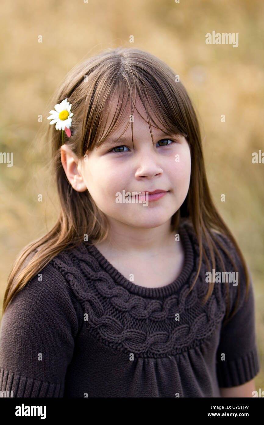 Young girl with a daisy in her hair Stock Photo - Alamy