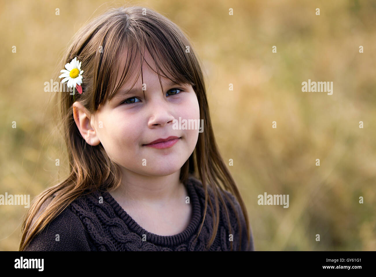 Young girl with a daisy in her hair Stock Photo - Alamy