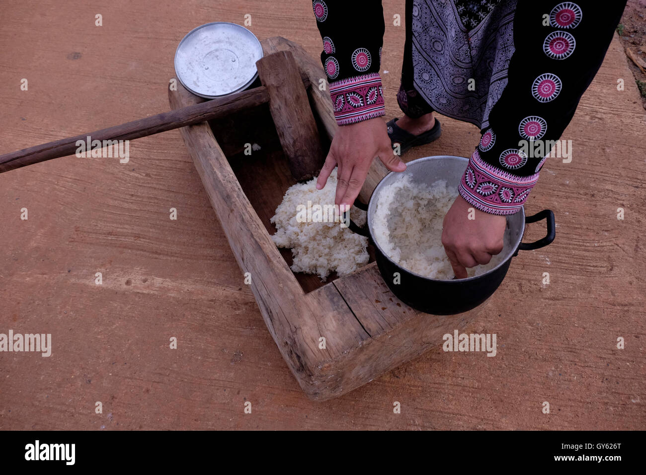 Member of Hmong Tribe in Mae Khi village preparing traditional sticky rice in Mae Rim District, Chiang Mai, northern Thailand. Many Hmong people migrated from Laos to Thailand following the victory of the Pathet Lao in the late 1970s. While some ended up in refugee camps, others settled in mountainous areas becoming one of the ethnic groups referred to as Hill Tribes in Thailand Stock Photo