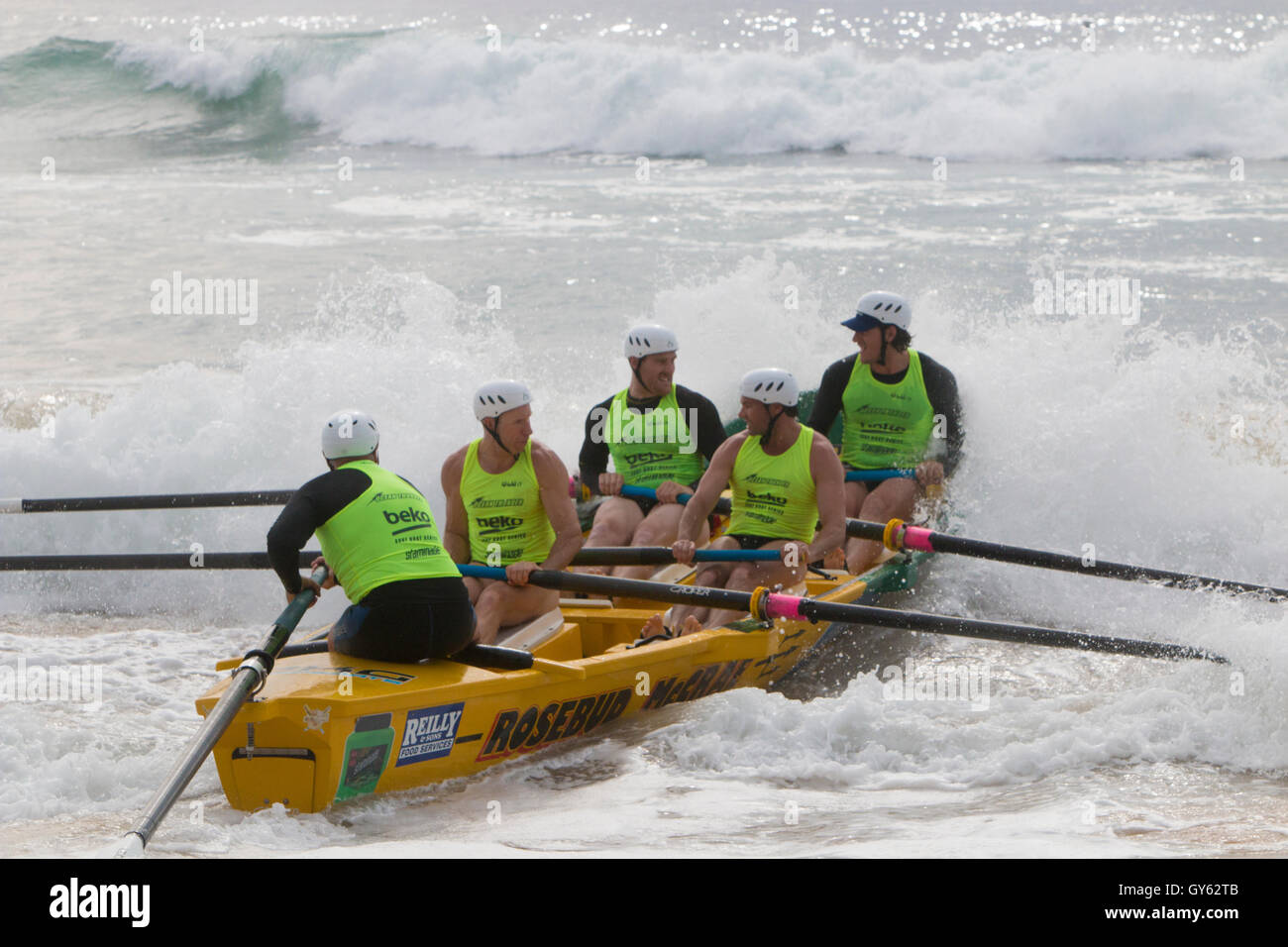 Traditional australian surf boat lifeguard rowing team off a Sydney