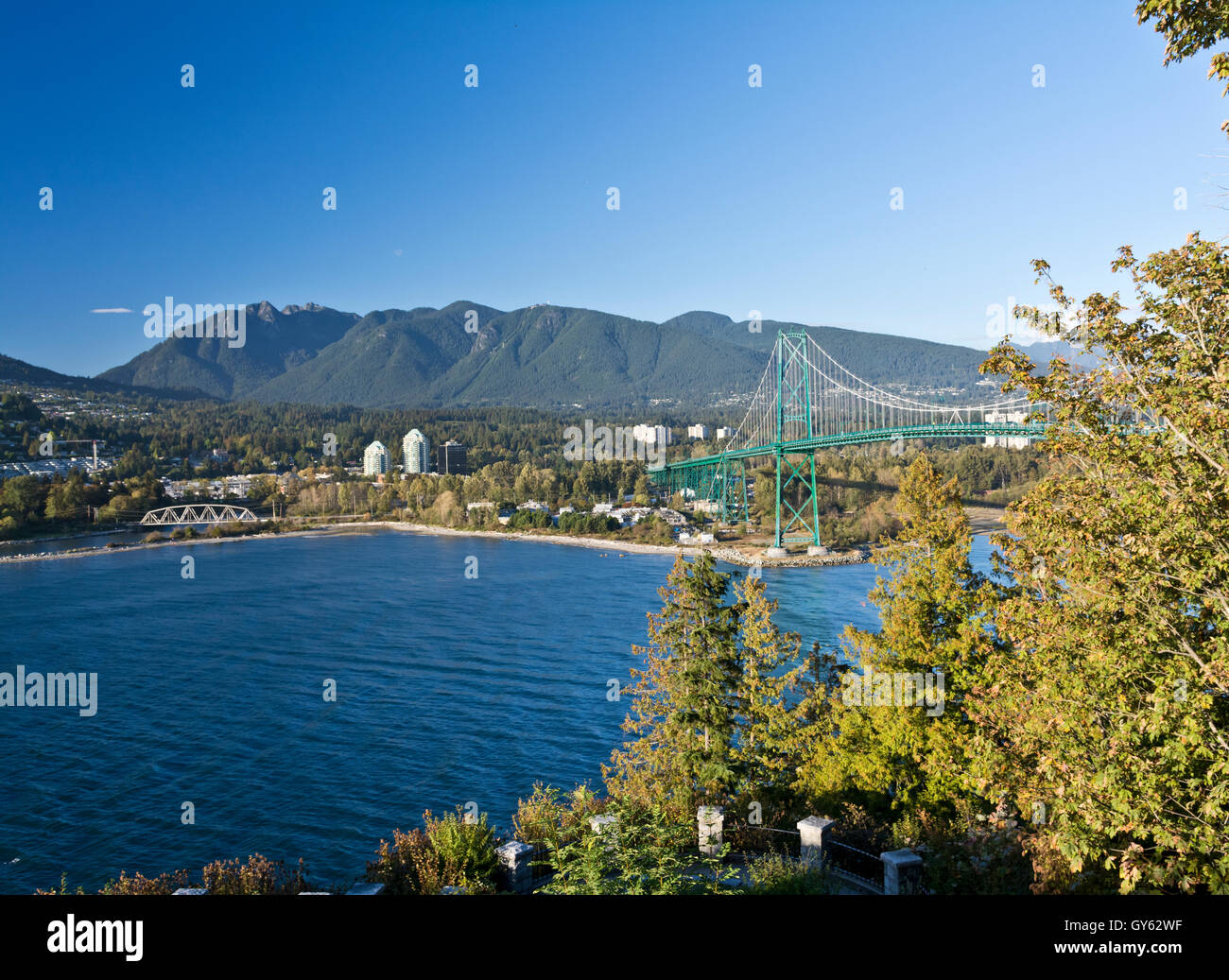 View of Lions Gate Bridge and North Vancouver, Grouse Mountain, Burrard Inlet, from Prospect Point in Stanley Park. Waters of Burrard Inlet. Stock Photo