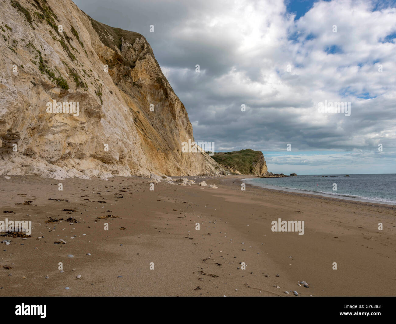 Landscape depicting the sandy shoreline at Man O'War beach, St Oswald's Bay on a fine summer day. Stock Photo
