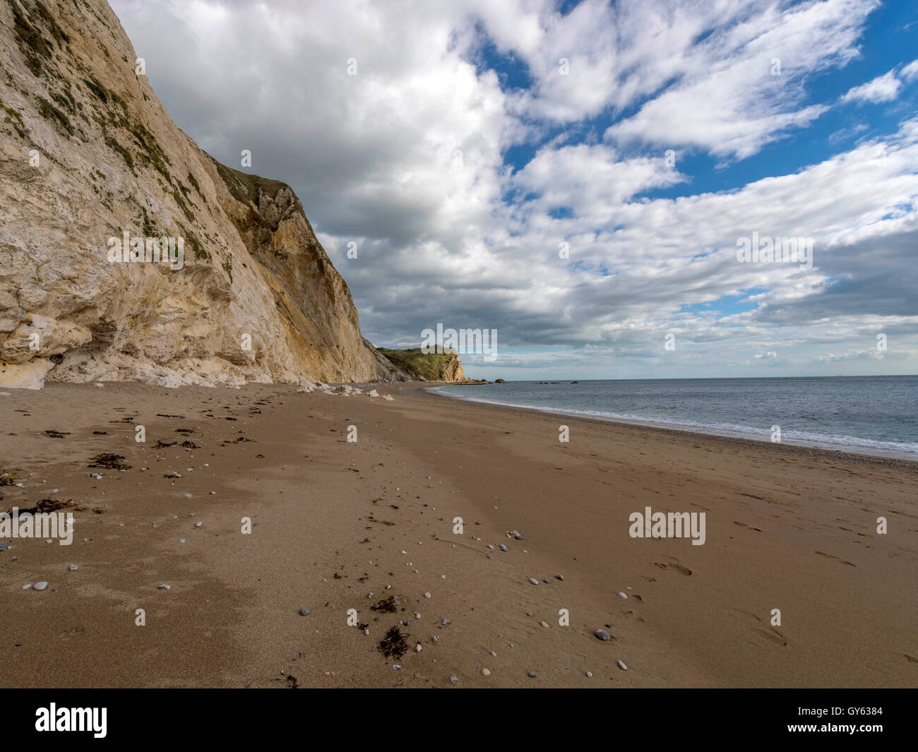 Landscape depicting the sandy shoreline at Man O'War beach, St Oswald's Bay on a fine summer day. Stock Photo