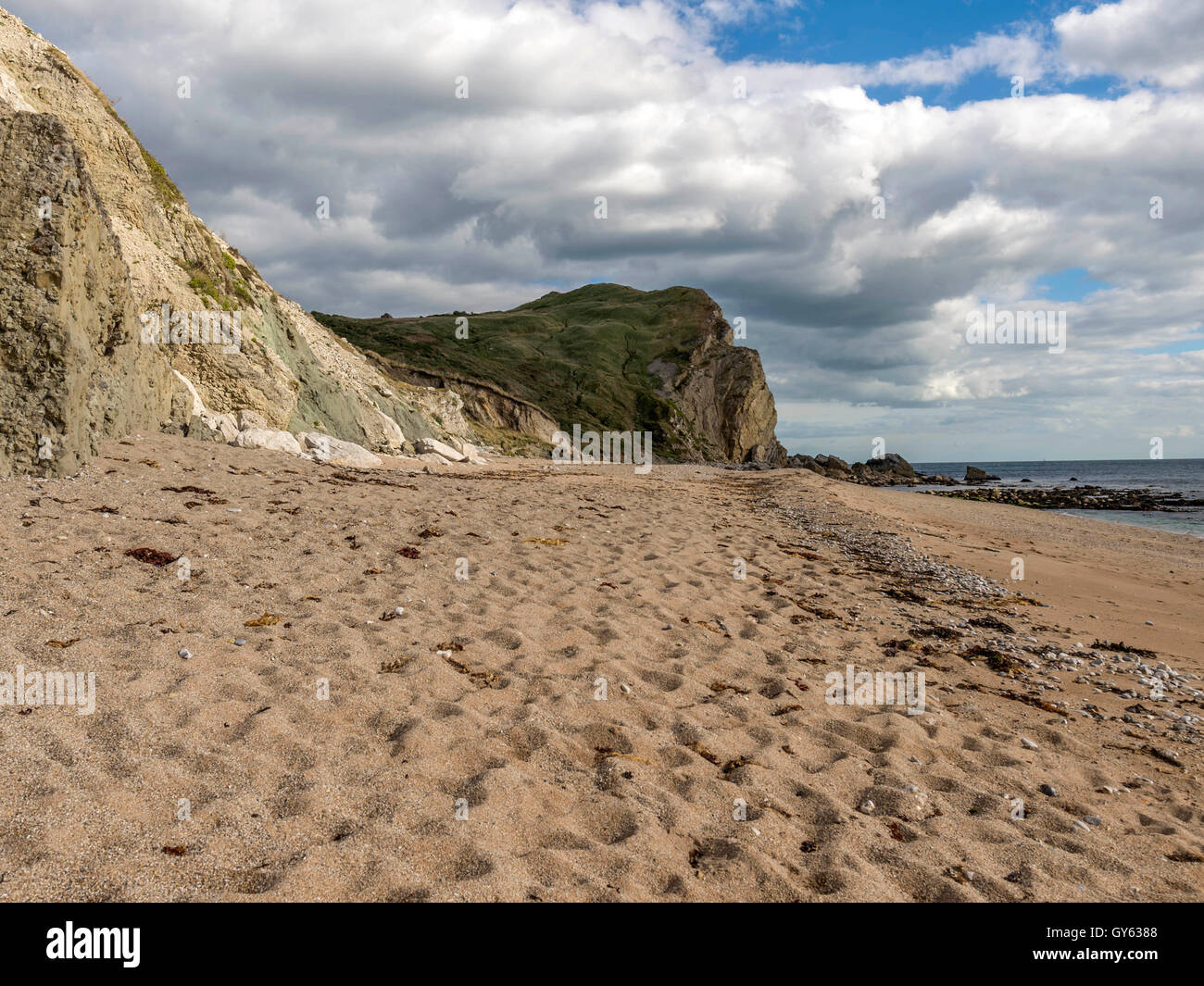 Landscape depicting the sandy Jurassic shoreline at Man O'War beach, St Oswald's Bay on a fine summer day. Stock Photo