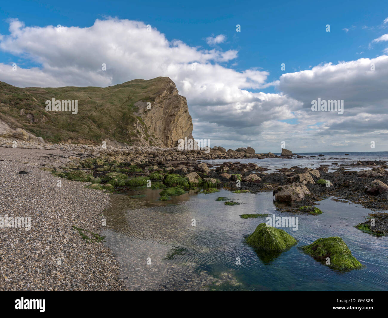 Landscape depicting the rocky Jurassic shoreline at Man O'War beach, St Oswald's Bay on a fine summer day. Stock Photo