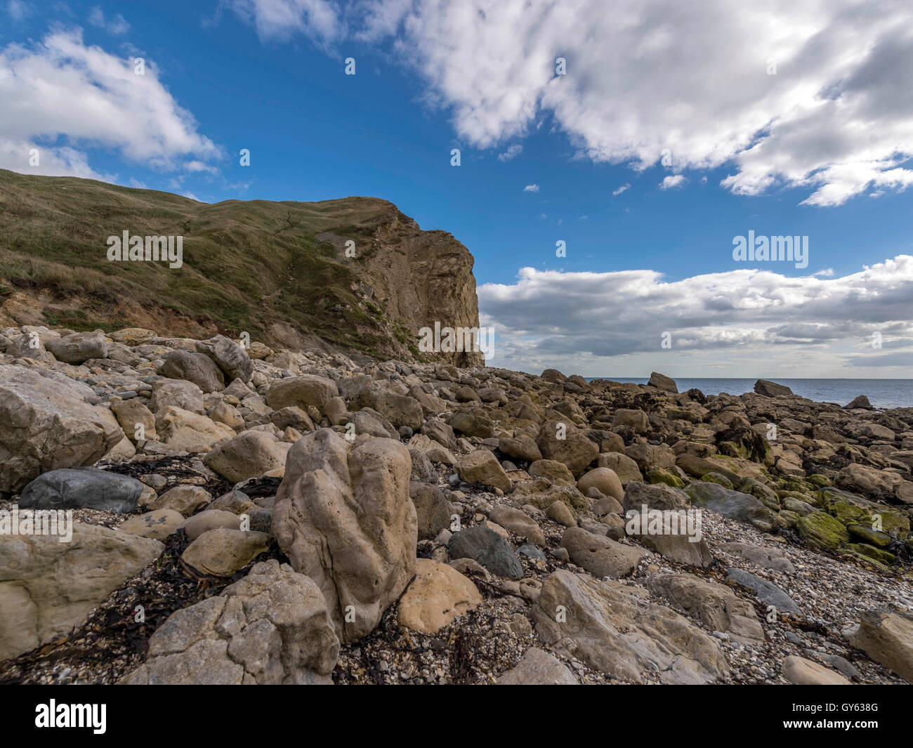Landscape depicting the rocky Jurassic shoreline of Man O'War beach, St Oswald's Bay on a fine summer day. Stock Photo