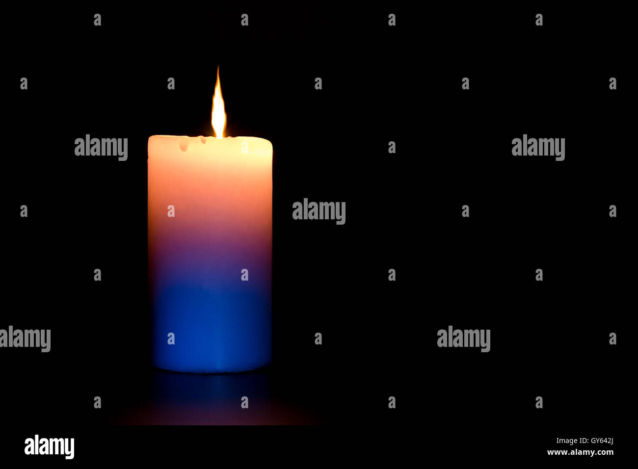 black flame candle burning in the dark Stock Photo