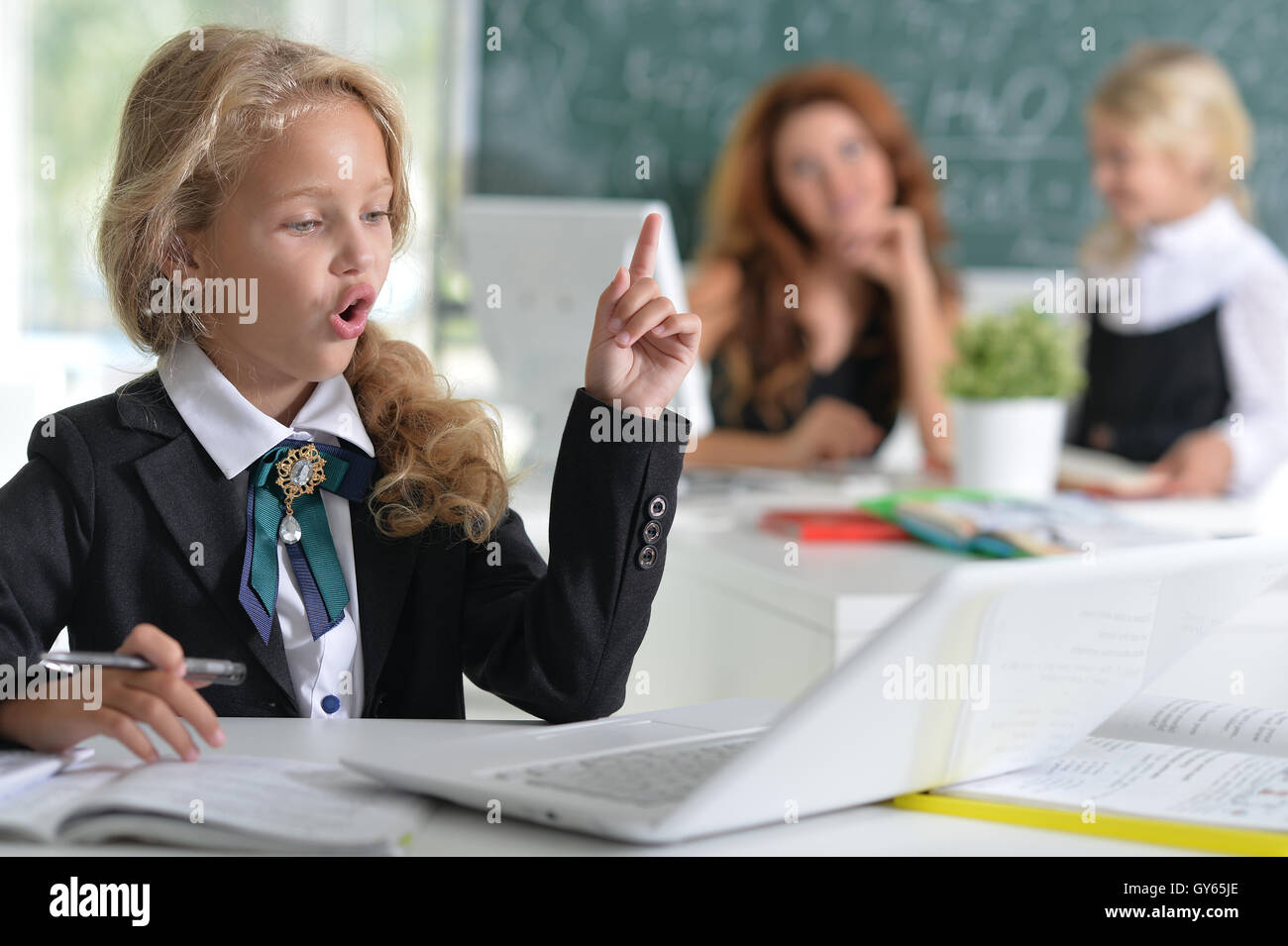 teacher with two girls at lesson Stock Photo - Alamy
