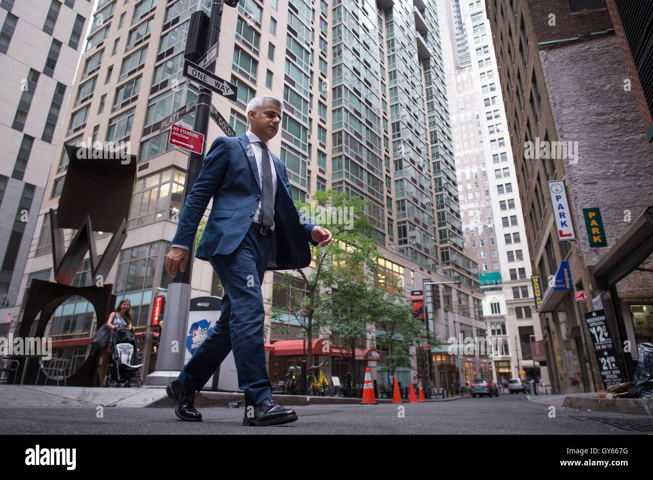 Mayor of London Sadiq Khan walks to his hotel in the Wall Street area of New York City during a three day visit to the US capital as part of his visit to North America, where he is due to attend a New York Mets baseball game and meet NYC Mayor Bill de Blasio. Stock Photo