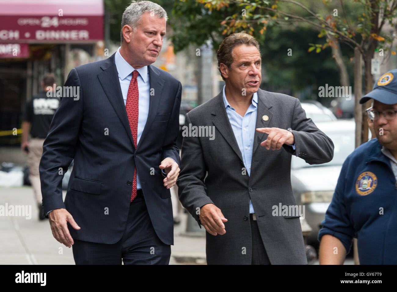 Chelsea, New York, USA. 18th Sept, 2016. New York State Governor Andre Cuomo and New York City Mayor (red tie) Bill de Blasio toured the site of the bomb explosion on West 23rd Street between Sixth and Seventh Avenues in Manhattan's Chelsea neighborhood, and then stopped at various local businesses to greet proprietors and residents. Credit:  PACIFIC PRESS/Alamy Live News Stock Photo