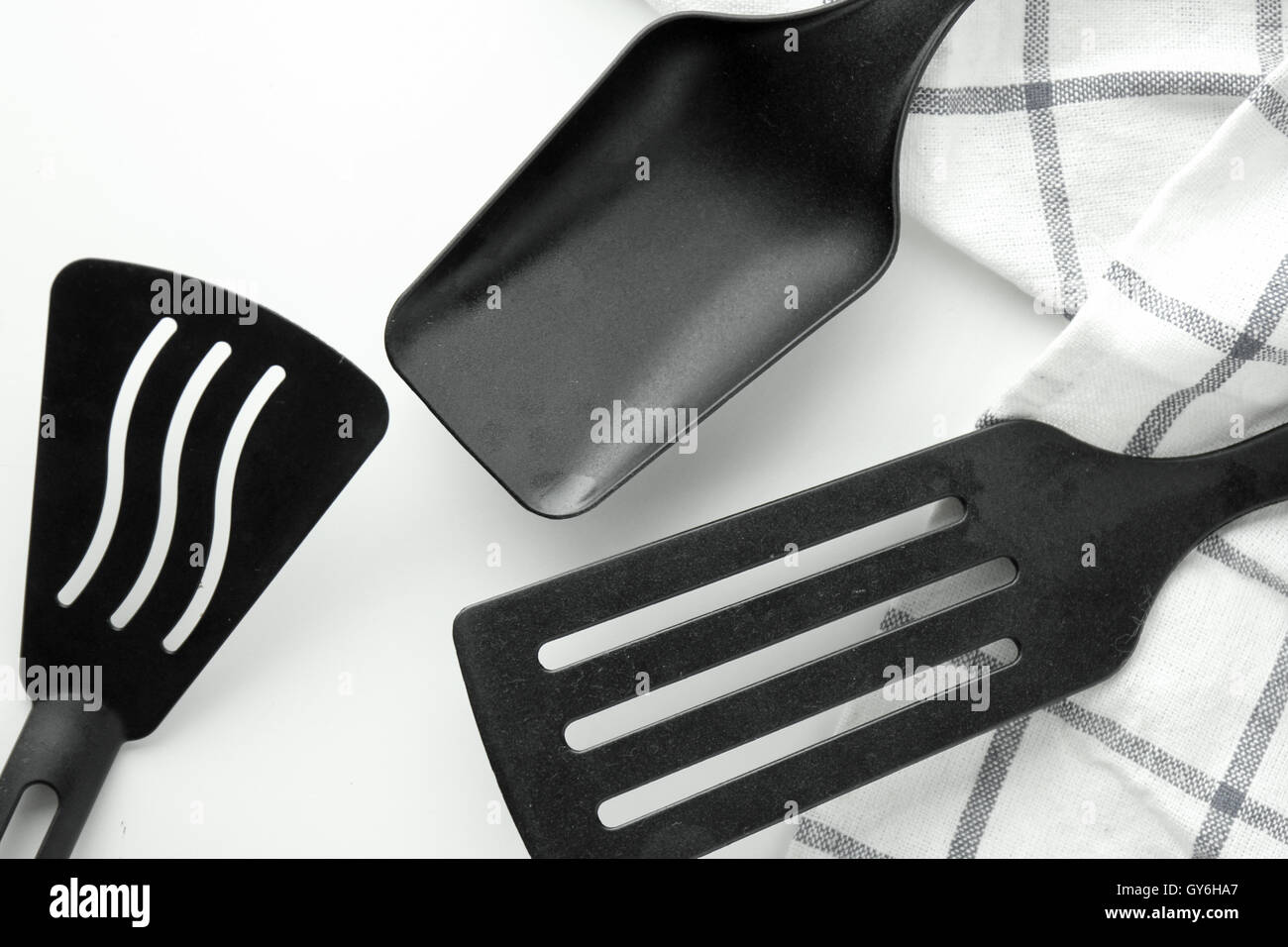 black ladle and spade of frying pan on the white table Stock Photo Alamy