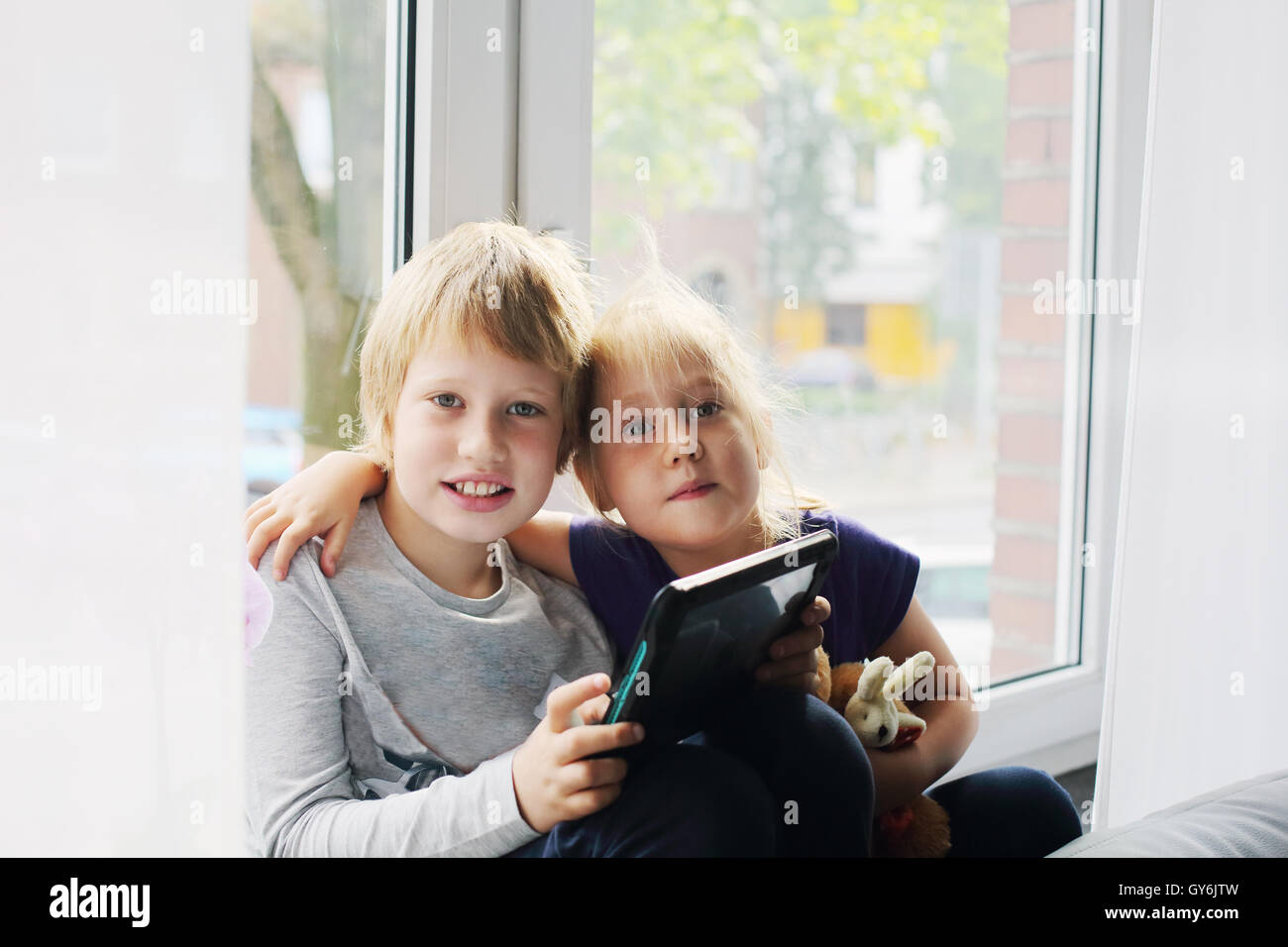 Portrait of autistic 8 years old boy with his 5 years old sister