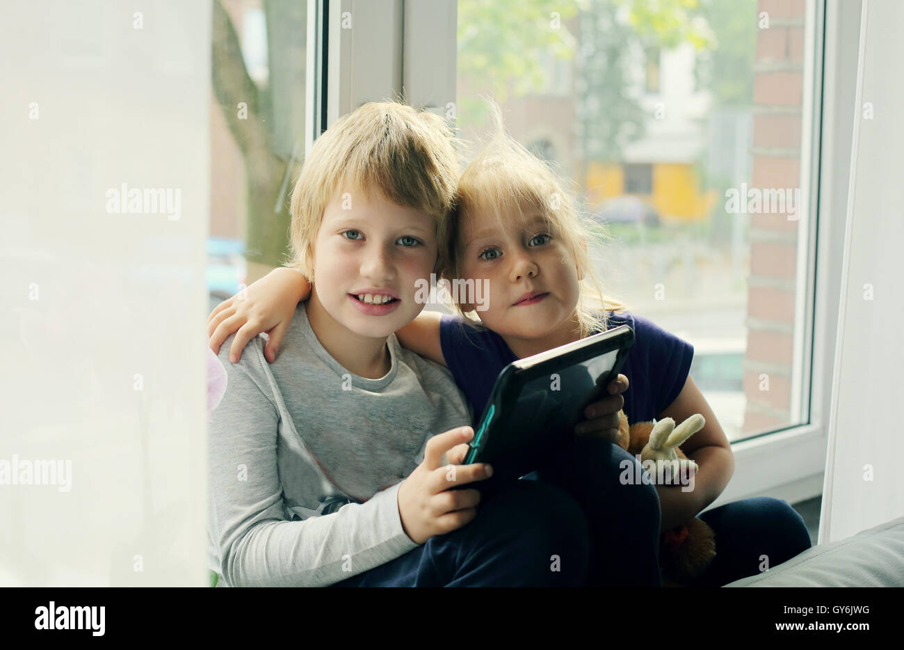 Portrait of autistic 8 years old boy with his 5 years old sister