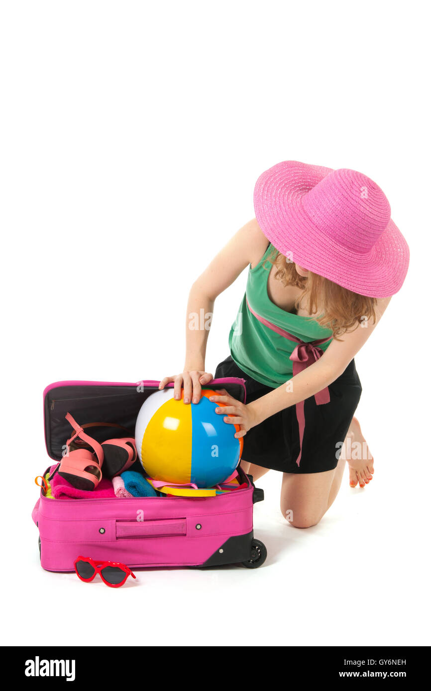 Packing the suitcase by a young woman Stock Photo - Alamy