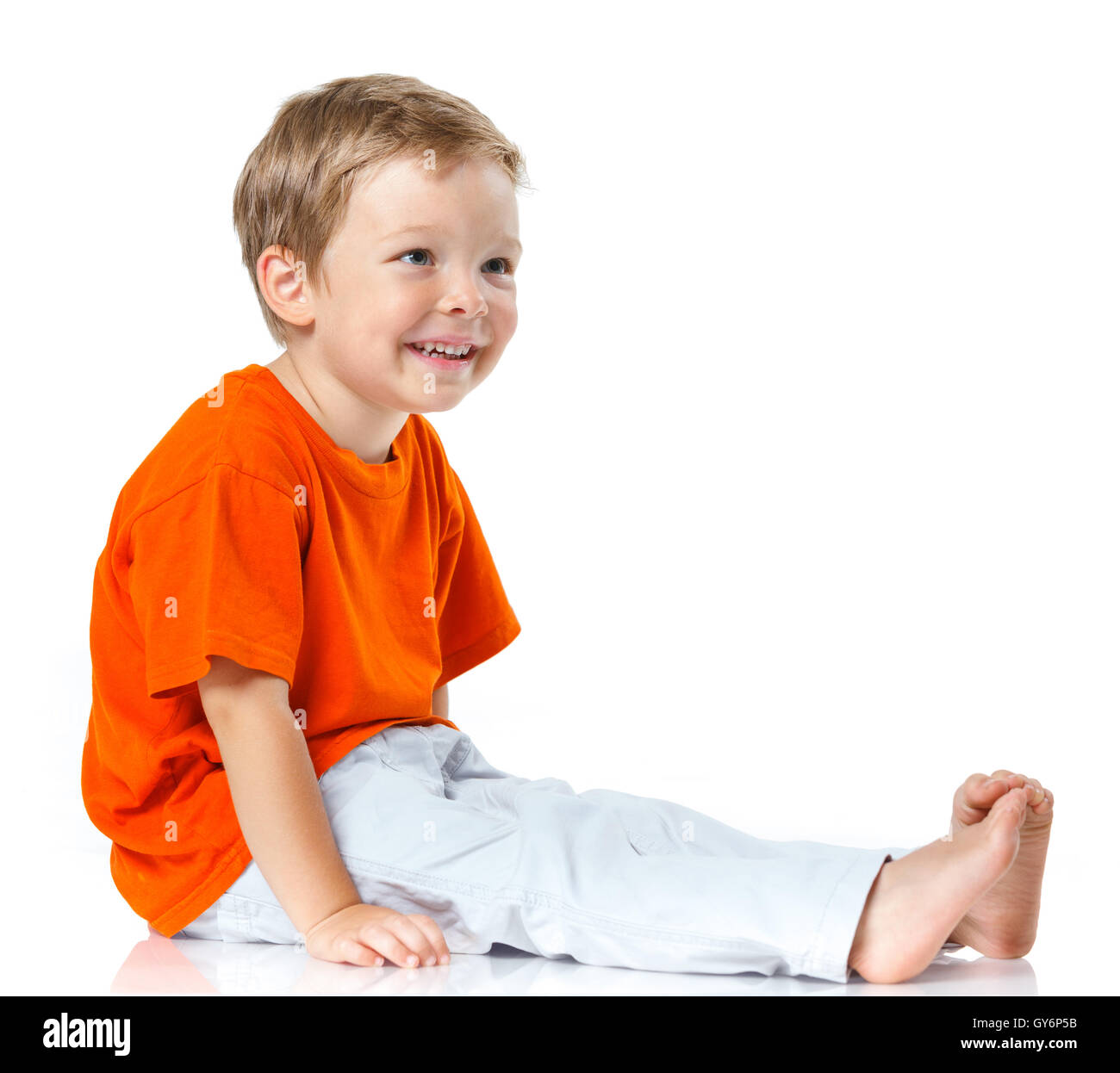 Happy boy sitting on the floor Stock Photo - Alamy