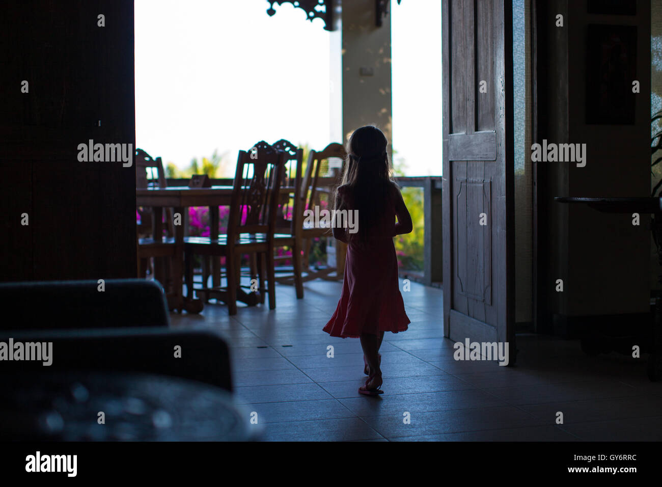 Silhouette of young girl in a doorway at big dark house Stock Photo - Alamy
