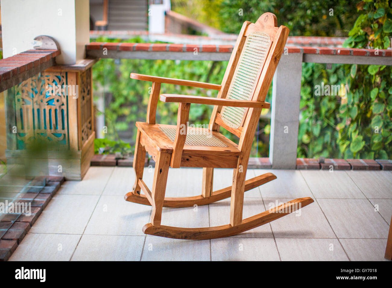 Wooden rocking chair on the terrace of an exotic hotel Stock Photo - Alamy