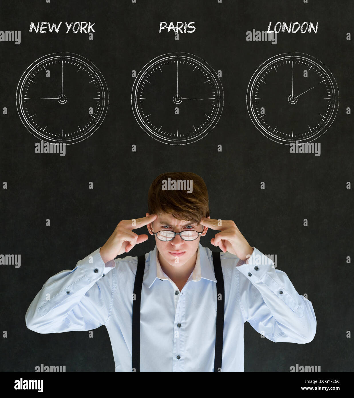 Businessman thinking with New York, Paris and London chalk time zone clocks on blackboard background Stock Photo