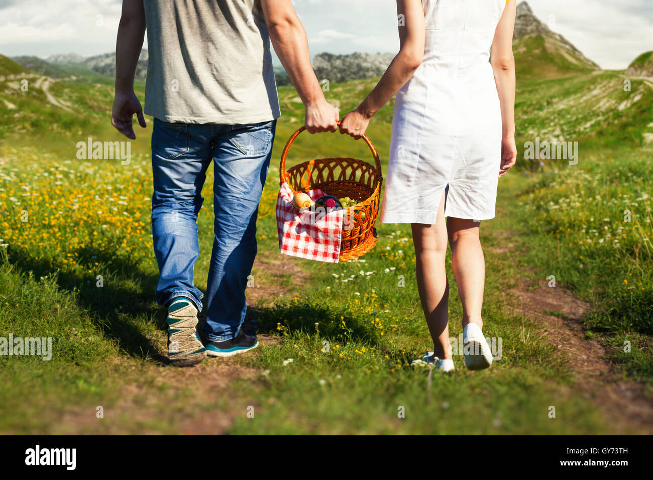 Young couple going with picnic basket Stock Photo
